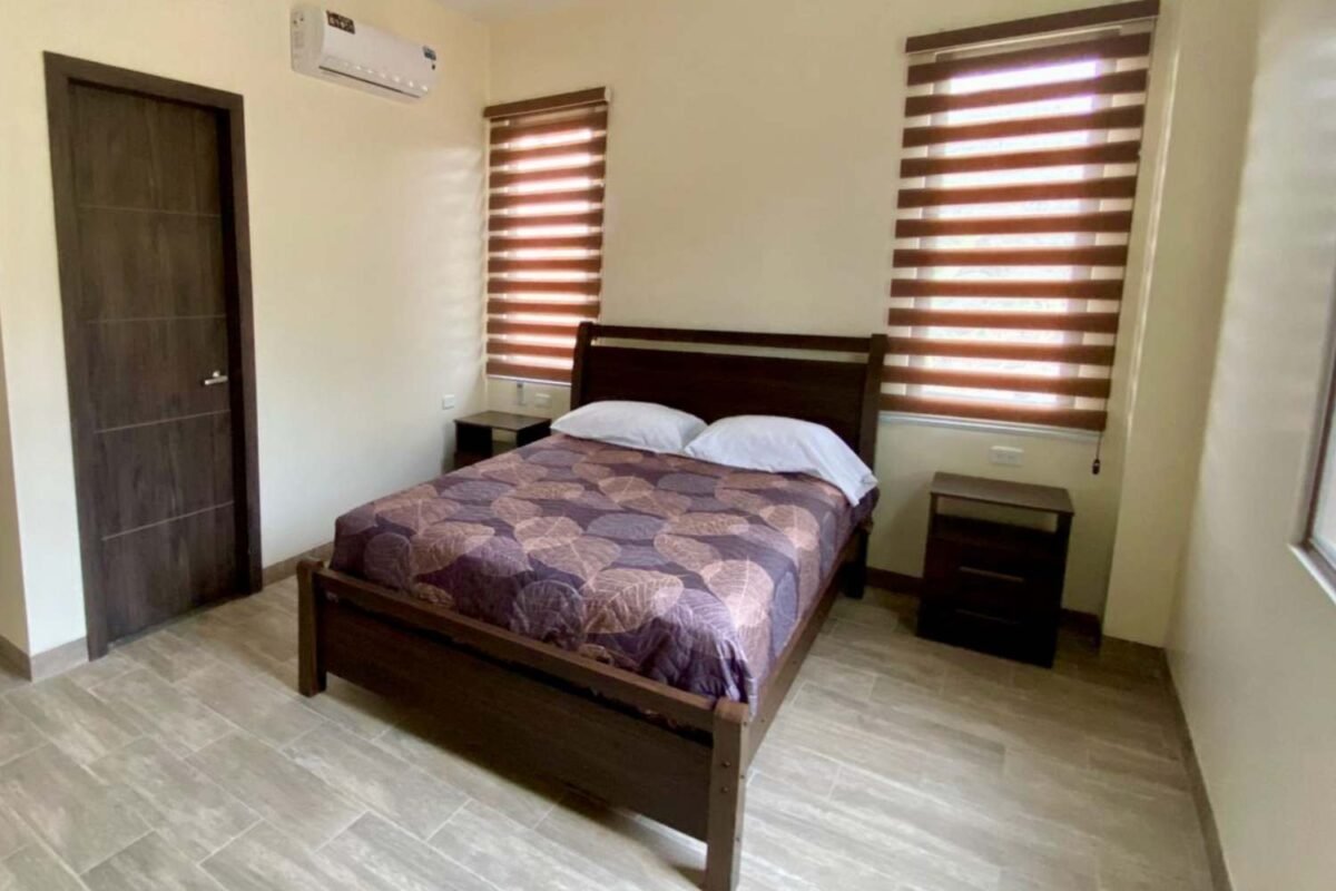 Bedroom with two nightstands and windows.