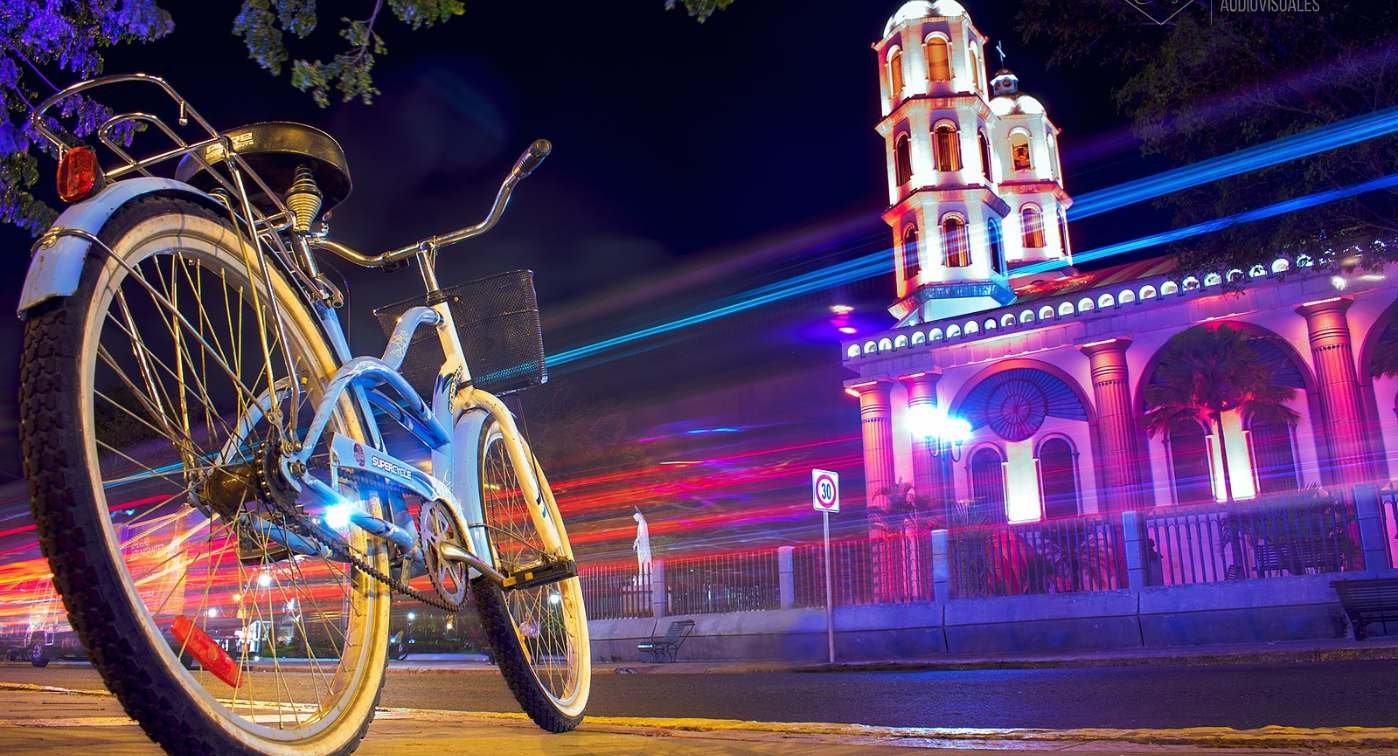 Bike at night with glowing chapel.