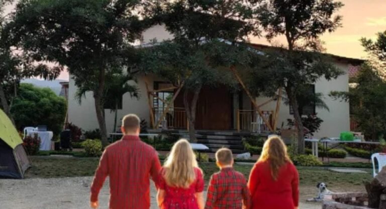 Family walking towards the house at sunset.